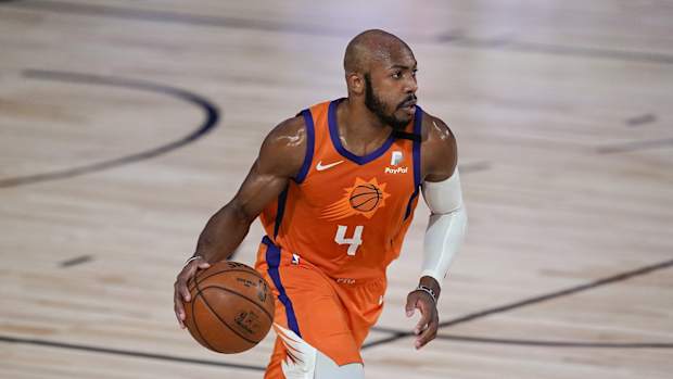 Phoenix Suns guard Jevon Carter (4) brings the ball up court against the Dallas Mavericks during the second half of an NBA basketball game Sunday, Aug. 2, 2020, in Lake Buena Vista, Fla.